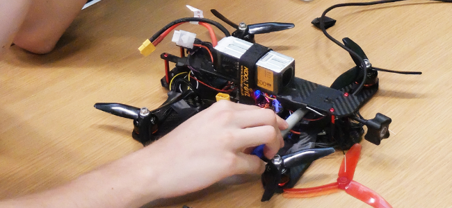 Engineering students working on drones during drone hackathon